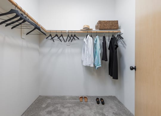 a walk in closet with a clothes rack and shoes on the floor  at Shoreline Village, Richland, WA, 99352