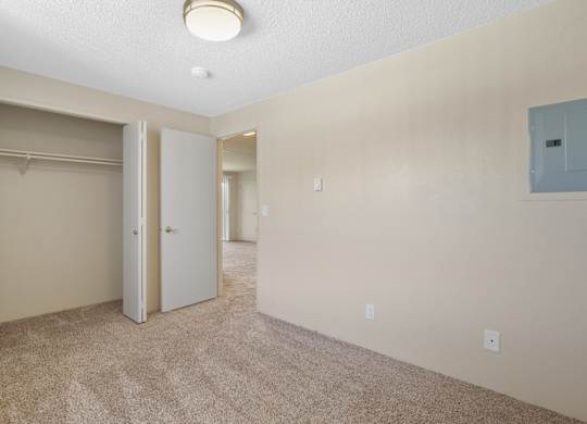 A room with a carpeted floor and a ceiling light.