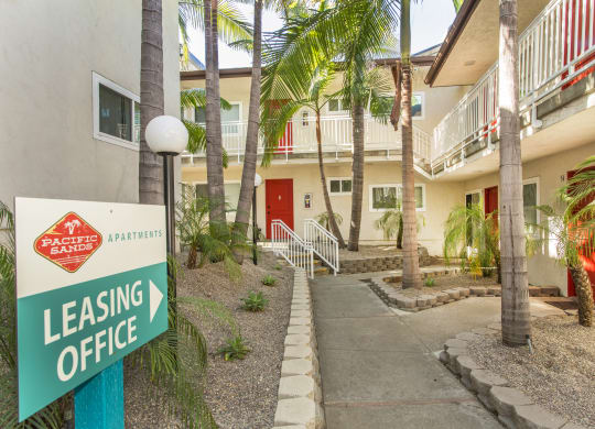 Pacific Sands walkway with Leasing Office sign and tropical landscaping at Pacific Sands, San Diego, CA, 92117