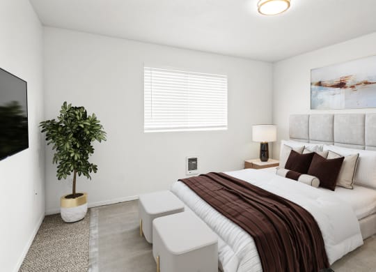 a large bedroom with white walls, a window on back wall and carpet. Staged with a queen-sized bed, side tables, a plant and a flat screen TV.at North Pointe, Idaho, 83854