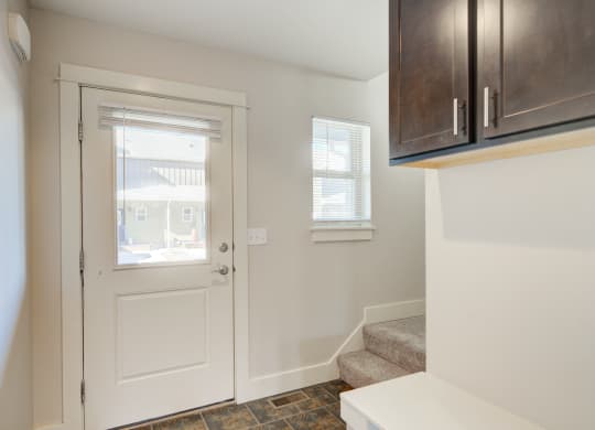 a entryway with a white door and a stairwell with a window at Copper Pines, Bozeman, MT, 59718