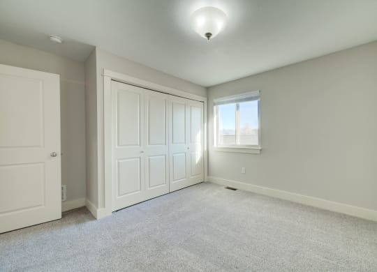 an empty room with two closets and a window at Copper Pines, Bozeman, MT, 59718