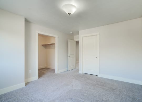 an empty living room with white walls and white doorways at Copper Pines, Bozeman, MT