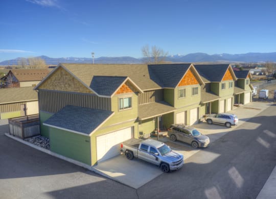 a row of houses with cars parked in front of them at Copper Pines, Montana