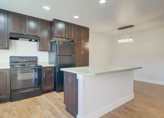 a kitchen with a large island and stainless steel appliances at Copper Pines, Bozeman