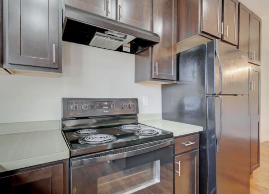 an empty kitchen with stainless steel appliances and wooden cabinets at Copper Pines, Bozeman, MT, 59718