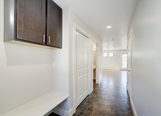 a entryway with a white door and a hallway with a door to a kitchen at Copper Pines, Montana