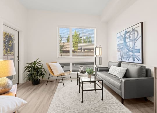 a living room with a couch and a chair and a window couch