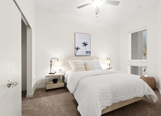 a bedroom with a bed and a ceiling fan at The Duo, Washington, 98466