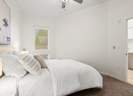 a white bedroom with a bed and a ceiling fan at The Duo, Washington, 98466