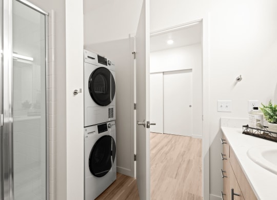 a bathroom with a washer and a dryer in it at The Duo, Washington