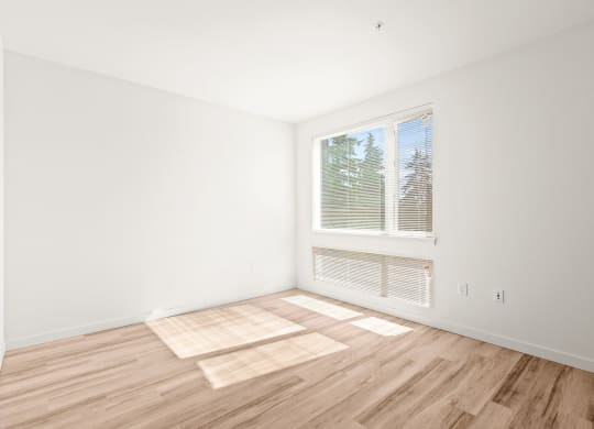 a living room with a large window and wooden floors at The Duo, University Place, WA
