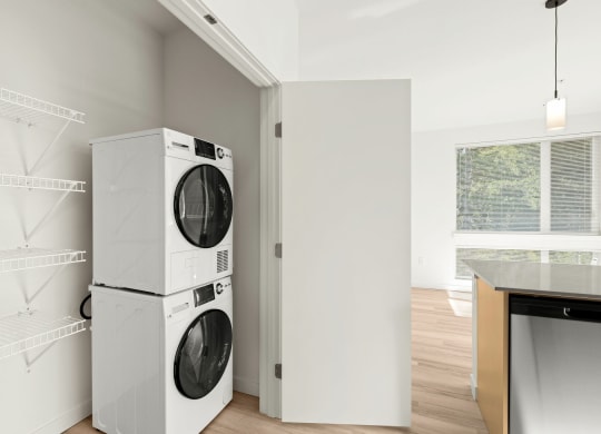 a white washer and dryer in a white room with a window at The Duo, Washington
