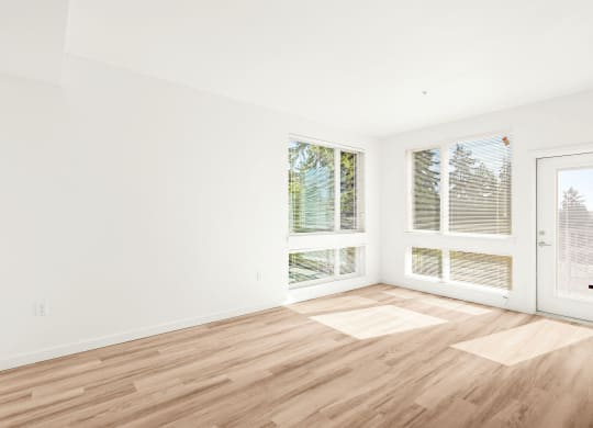 a living room with a hard wood floor and two windows at The Duo, University Place