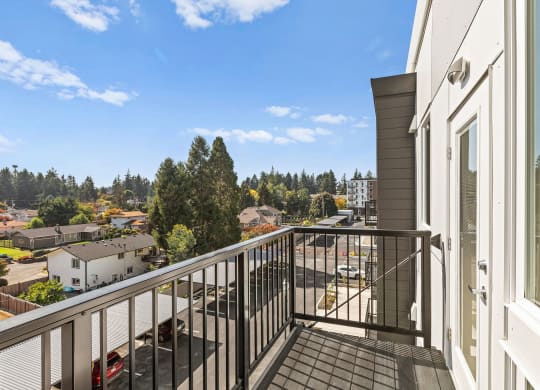 the view from the balcony of a home with a balcony railing at The Duo, University Place, WA 98466