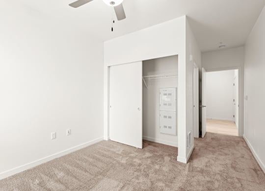 an empty living room with white walls and a ceiling fan at The Duo, Washington, 98466