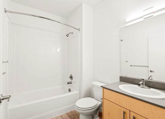 a bathroom with a sink toilet and a shower at The Duo, University Place, WA