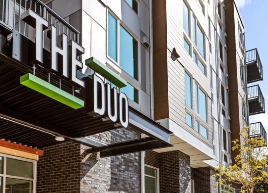 a building with a sign that reads the 1100 at The Duo, University Place Washington