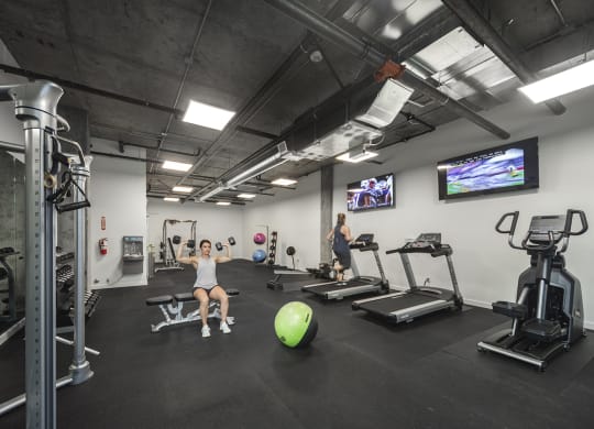 Gym with treadmills, an elliptical, weight machines, free weights, benches, an exercise ball and tvs at 6 Wood Flats, Lacey, WA