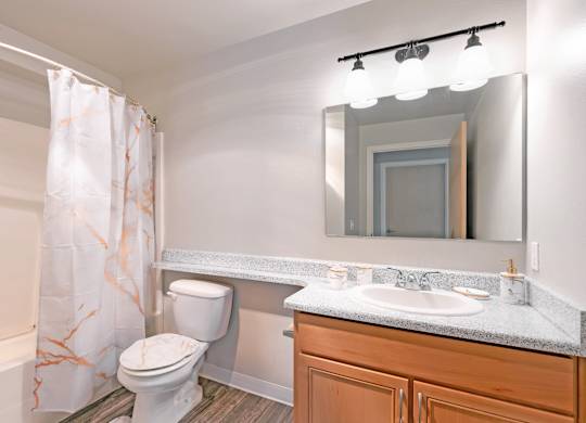 Spacious bathroom with oversized vanity and shower tub combination in a 728 square foot apartment at 6Wood Flats Lacey
