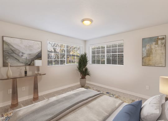 Bedroom with two large windows, staged bed, carpet, side tables and art on walls.at Capitol Crossing, Olympia