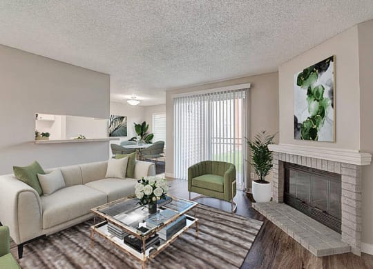 Living room with hardwood flooring, a large fireplace, and sliding glass doors to the private patio behind. Staged with a couch, chairs, and coffee table. at Pointe East, Fife, Washington