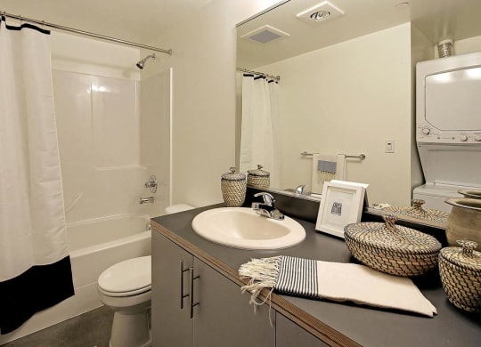 Bathroom with vanity and sink, toilet, and bath/shower combination.at 19th & Mercer, Seattle Washington
