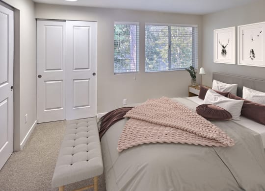Bedroom that will fit a queen sized bed comfortably. Carpeted with sliding closet doors and 3 medium windows.at Edmonds Gateway, Washington