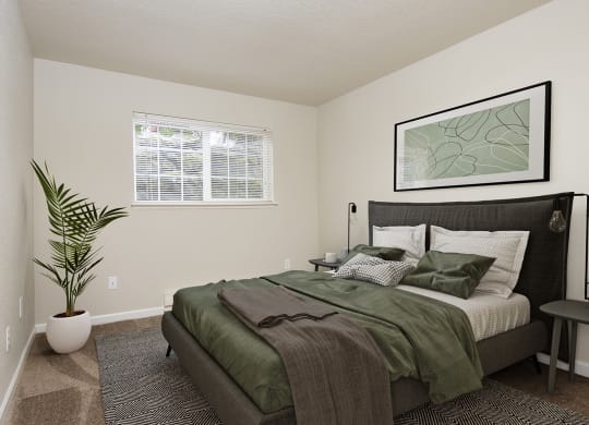 Bedroom with queen size bed, two side tables, and window at University Glen, University Place, 98466