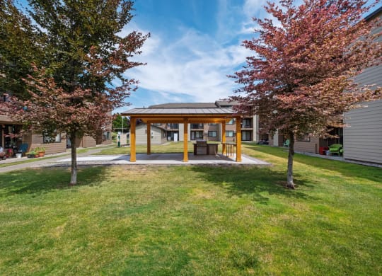 a covered area in the middle of a grassy area with trees on either side at Brix, Washington, 99362