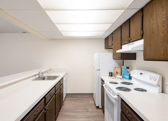 the preserve at ballantyne commons apartment kitchen with white appliances and wood cabinets