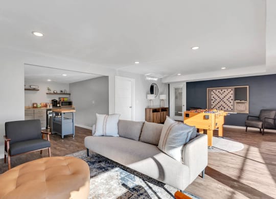 Clubhouse with kitchen, coffee station, microwave, game room with foosball, wall scrabble, couch, chair, ottoman.at Castlerock, Washington, 98801
