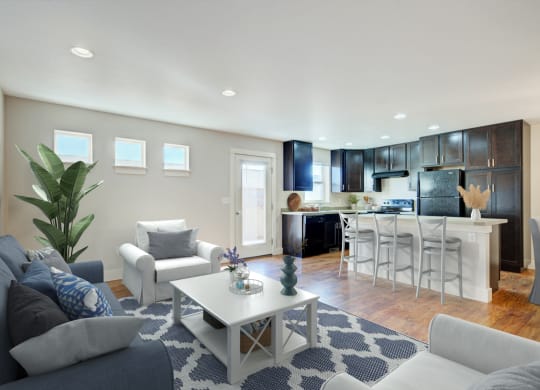 a living room with couches and a coffee table in front of a kitchen at Copper Pines, Bozeman, MT, 59718