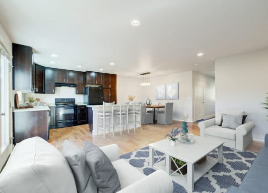 a living room and kitchen with white couches and a table at Copper Pines, Montana