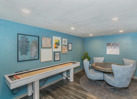 Lounge area with hardwood floors, shuffle board, and game table and chairs.at Cedarwood, Renton Washington