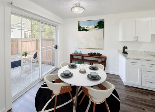 an open kitchen and dining room with a white table and chairs at Woodcreek, Poulsbo, 98370