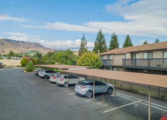 a parking lot with cars parked in front of a hotel building at Cedarwood, Washington