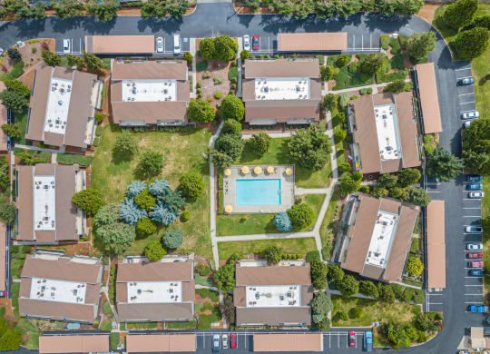 an aerial view of apartment homes with a pool in the middle at Cedarwood Apartments at Cedarwood, Wenatchee, WA 98801
