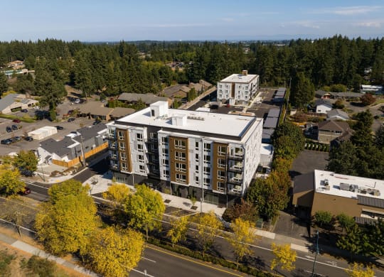an aerial view of a city with buildings and trees at The Duo, University Place, WA