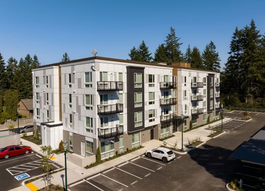 an aerial view of an apartment building in a parking lot at The Duo, University Place Washington 