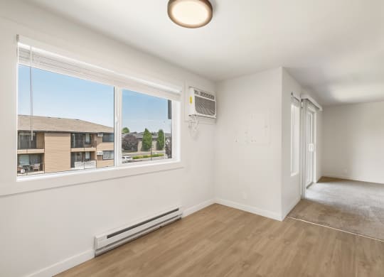 a dining room with a large window and hardwood floors  at Brix, Walla Walla