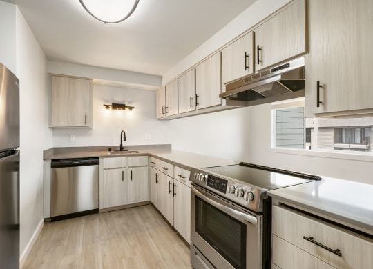 a kitchen with white cabinets and stainless steel appliances  at Brix, Washington
