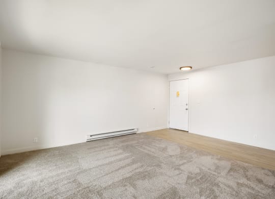 a living room with carpet, faux wood floors and white walls  at Brix, Washington