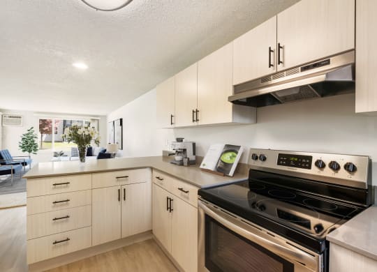 a kitchen with white cabinets and stainless steel appliances  at Brix, Walla Walla, WA, 99362