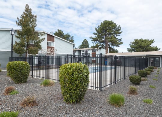 A swimming pool that's surrounded by a black wrought iron fence at Wildflower, Washington