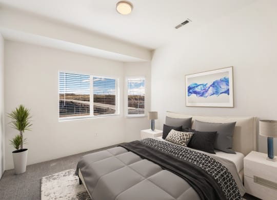 a bedroom with white walls and a large sunny window. Staged with a queen-size bed, side tables, and a plant. at Shoreline Village, Washington