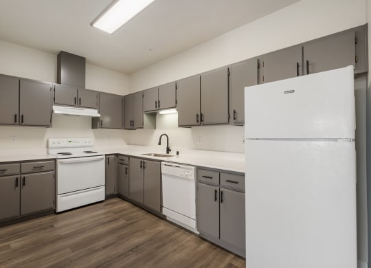 a kitchen with white appliances and gray cabinets at Shoreline Village, Washington, 99352