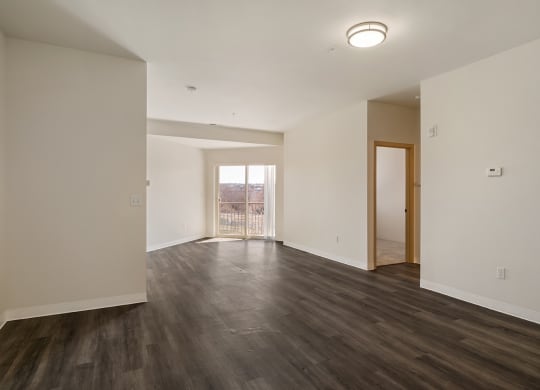 Living room with wood flooring, white walls and overhead lighting.at Shoreline Village, Richland, 99352