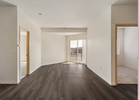 Open living room with hardwood flooring, white walls and filled with natural light.at Shoreline Village, Richland, WA