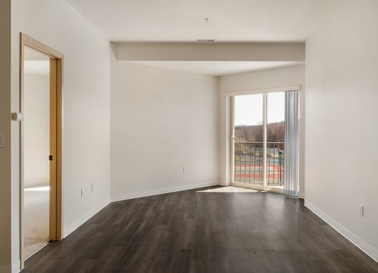 a spacious living room with white walls and sliding glass doors to the private balcony.at Shoreline Village, Richland, WA 99352